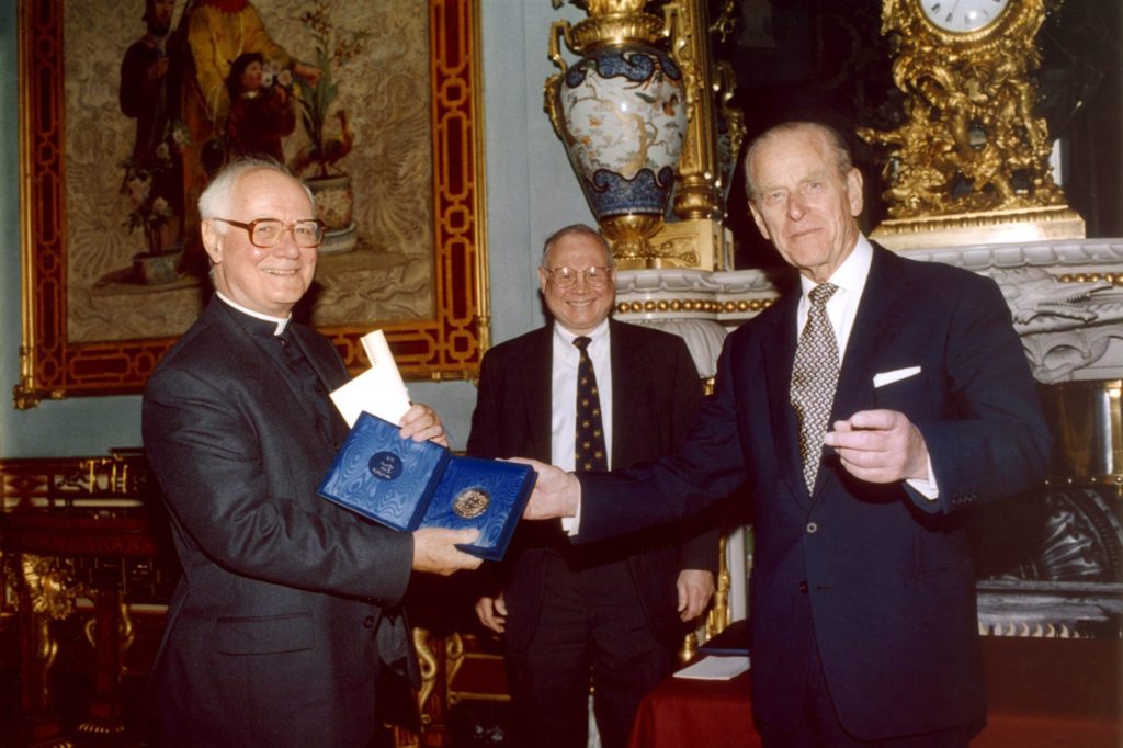 John C. Polkinghorne 2002 Laureate of Templeton Prize accepting award from Prince Philip, Duke of Edinburgh with John Templeton Jr. at palace